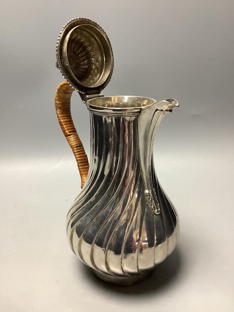 A George III silver hot water jug of wrythen baluster form